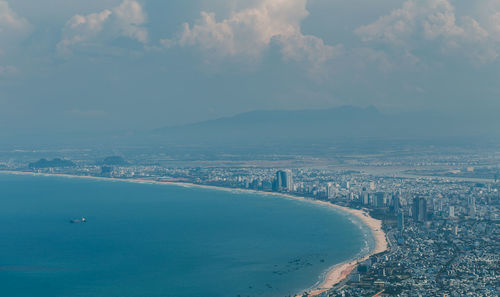 Aerial view of sea against cloudy sky