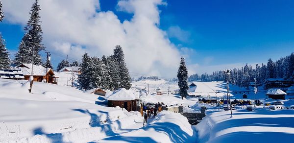 Panoramic view of snow covered trees against sky