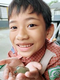 Portrait of smiling boy holding toy