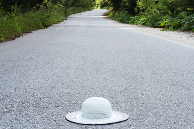 Close-up of white sun hat on road