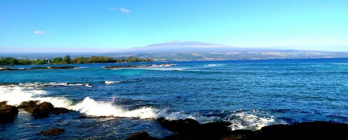 Scenic view of sea against blue sky