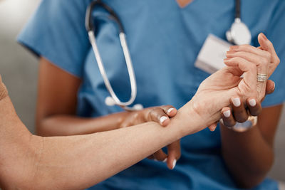 Midsection of doctor examining patient