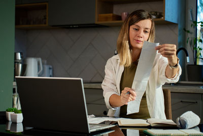 Young woman using laptop at office