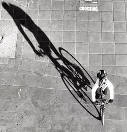 High angle view of man riding bicycle on street