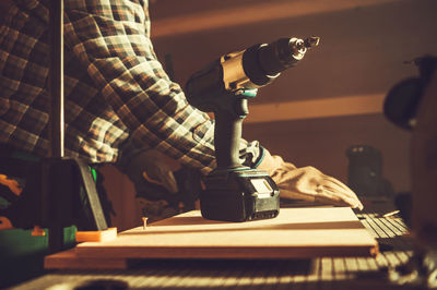 Midsection of man playing piano