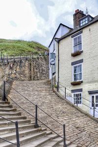 Staircase and by building against sky