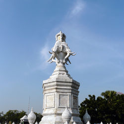 Low angle view of statue against blue sky