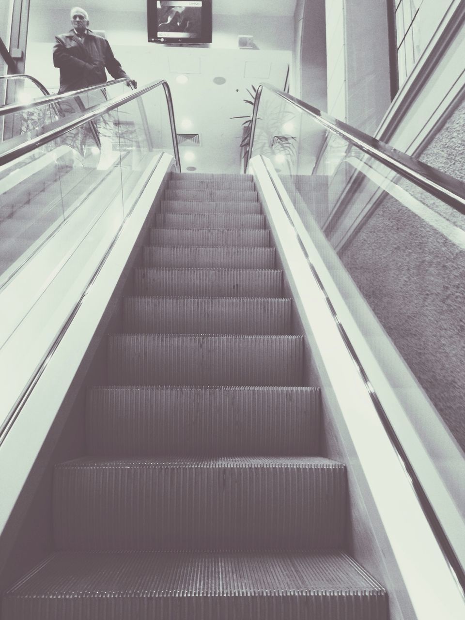 architecture, steps and staircases, built structure, steps, staircase, low angle view, modern, railing, escalator, building exterior, indoors, building, the way forward, diminishing perspective, city, high angle view, no people, office building, day, reflection