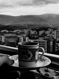 Close-up of coffee cup against sky