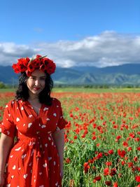 Close-up of red poppy flowers in field