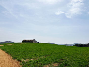 House on field against sky