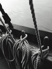 Close-up of rope tied to boat moored on sea