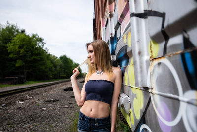 Full length of woman standing on railroad tracks