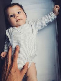 Portrait of cute baby girl on bed