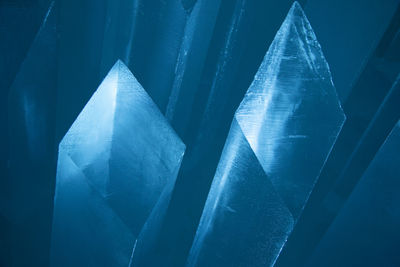 Blue ice pillars illuminated by blue light, diamond shaped