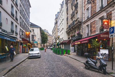 Cars on street amidst buildings in city
