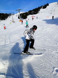 Woman skiing on snowy field during winter