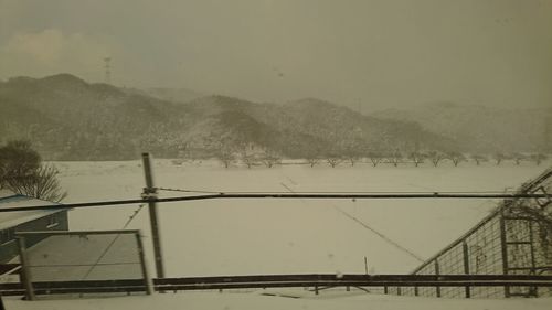 Scenic view of mountains against clear sky during winter