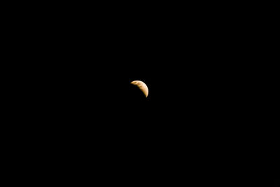 Low angle view of half moon against sky at night