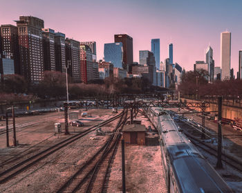 High angle view of railroad tracks amidst buildings in city