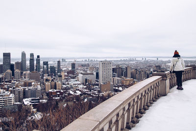 Buildings in city against sky during winter