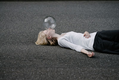 Rear view of siblings lying on floor