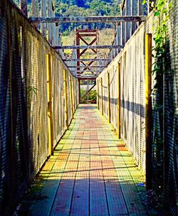 Narrow walkway leading to bridge