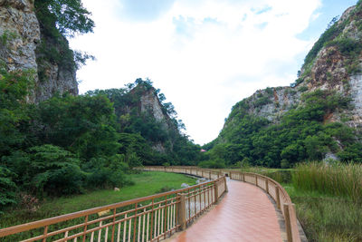 Bridge over mountain against sky