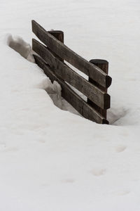 Bench on snow covered land