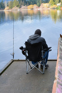 Rear view of man fishing at lake