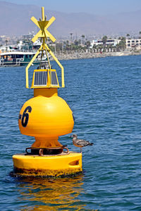 Yellow floating on sea against sky