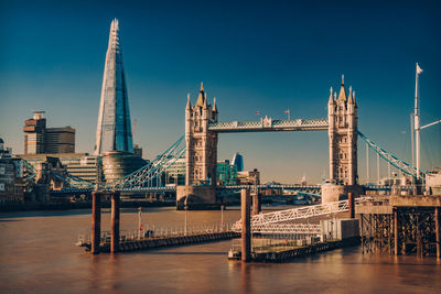 Bridge over river with city in background