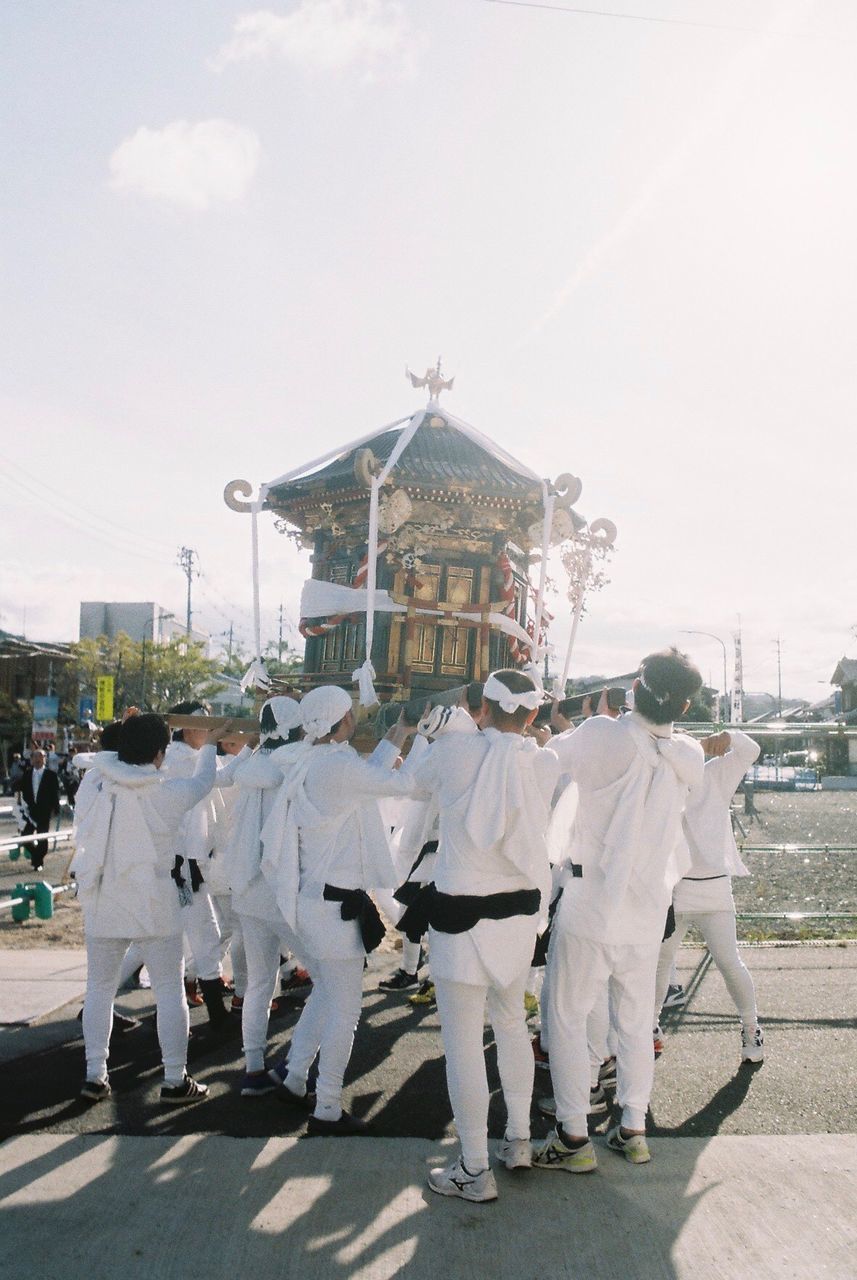 group of people, architecture, real people, sky, celebration, day, built structure, city, building exterior, crowd, traditional clothing, men, large group of people, arts culture and entertainment, clothing, street, nature, costume, outdoors, festival, uniform