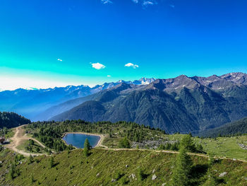 Scenic view of mountain range against blue sky