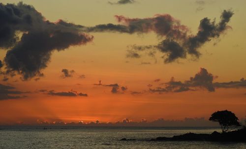 Scenic view of sea against orange sky