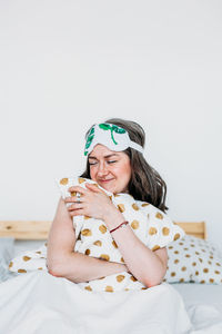 Portrait of woman sitting on bed