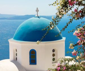 View of blue and white building by sea against sky