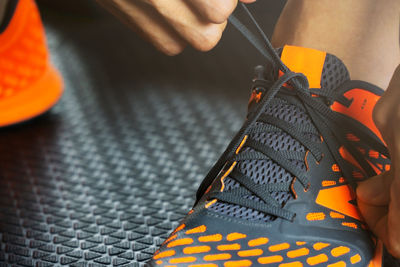 Close-up of person tying shoelace