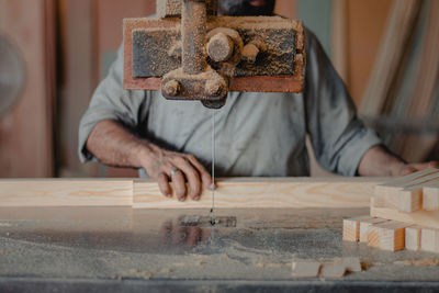 Midsection of man working on table