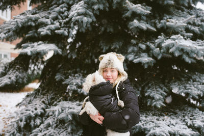 Portrait of man standing in snow