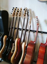 Close-up of guitars against wall