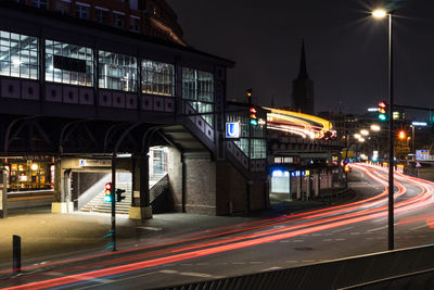 Light trails on road along buildings at night