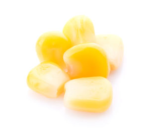 Close-up of yellow slices over white background