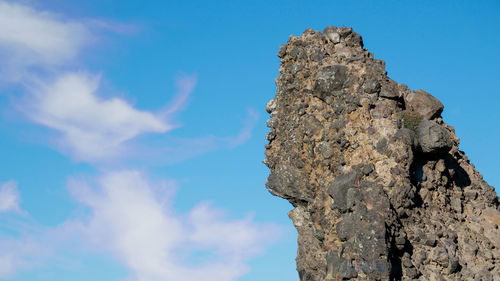 Low angle view of rock formation against sky