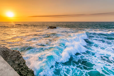 Scenic view of sea against sky during sunset