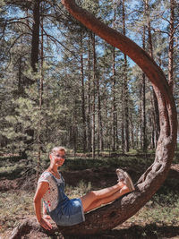 Reflection of woman on tree in forest