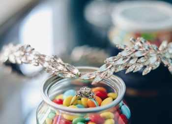 Close-up of jewelry over multi colored candies