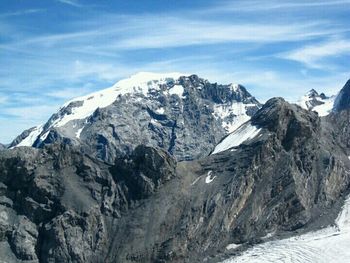 Scenic view of snow covered mountains against sky