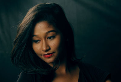 Close-up of beautiful young woman looking down