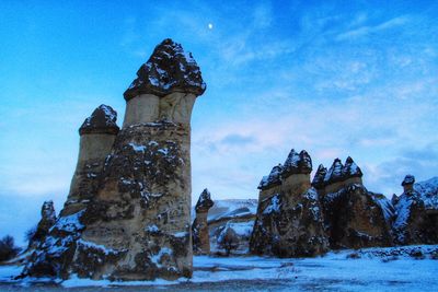 Low angle view of tower against sky during winter